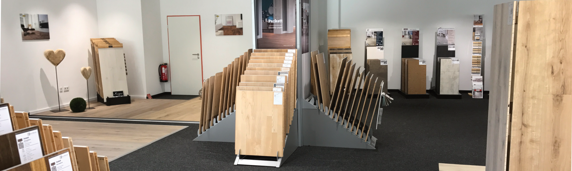 Indoor-Ausstellung von Böden in Holzoptik - Vinyl, Laminat und Pakett auf speziellen Ständern